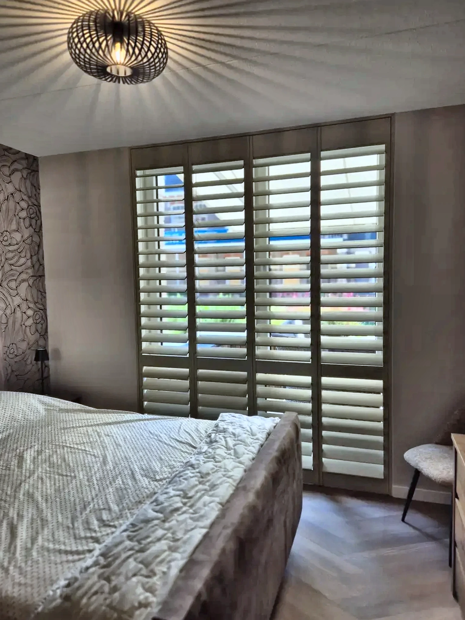 Witte houten shutters in een slaapkamer
