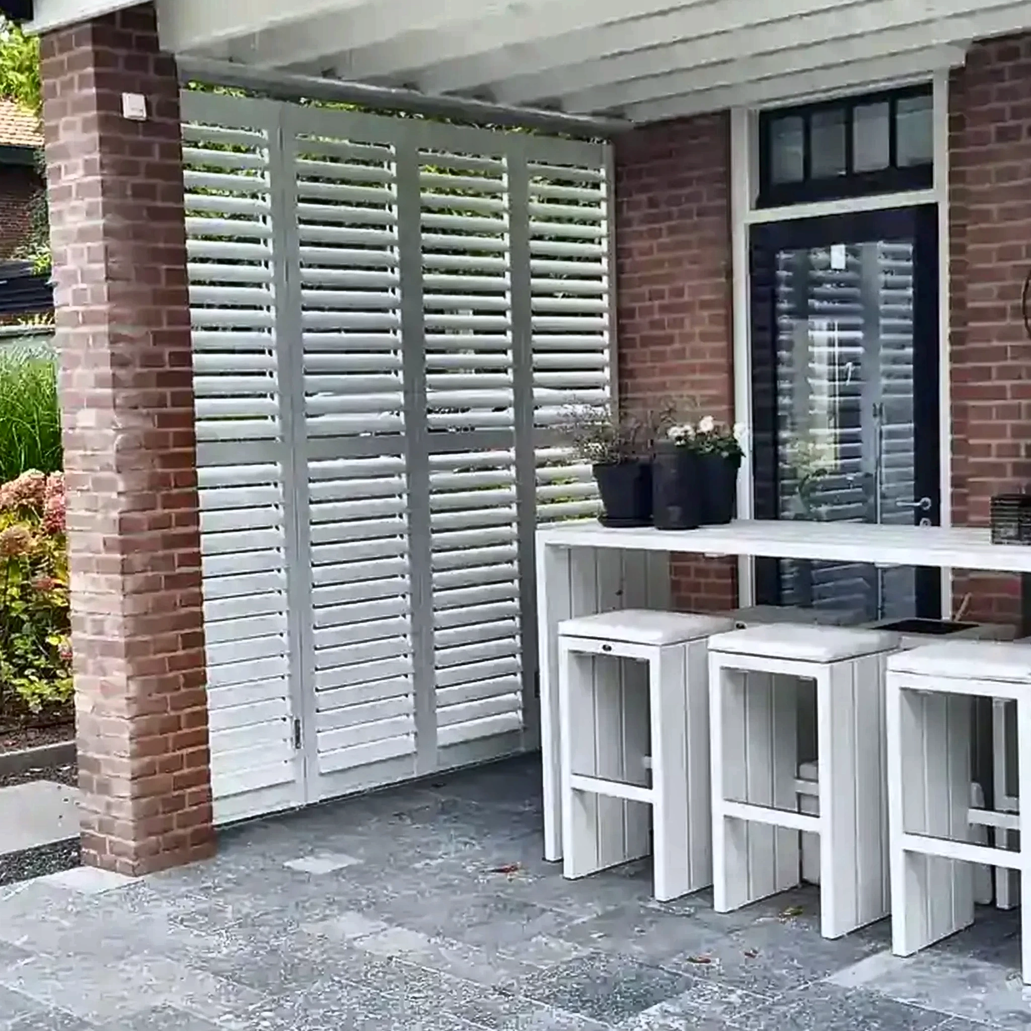 Witte aluminium shutters bij een overkapping
