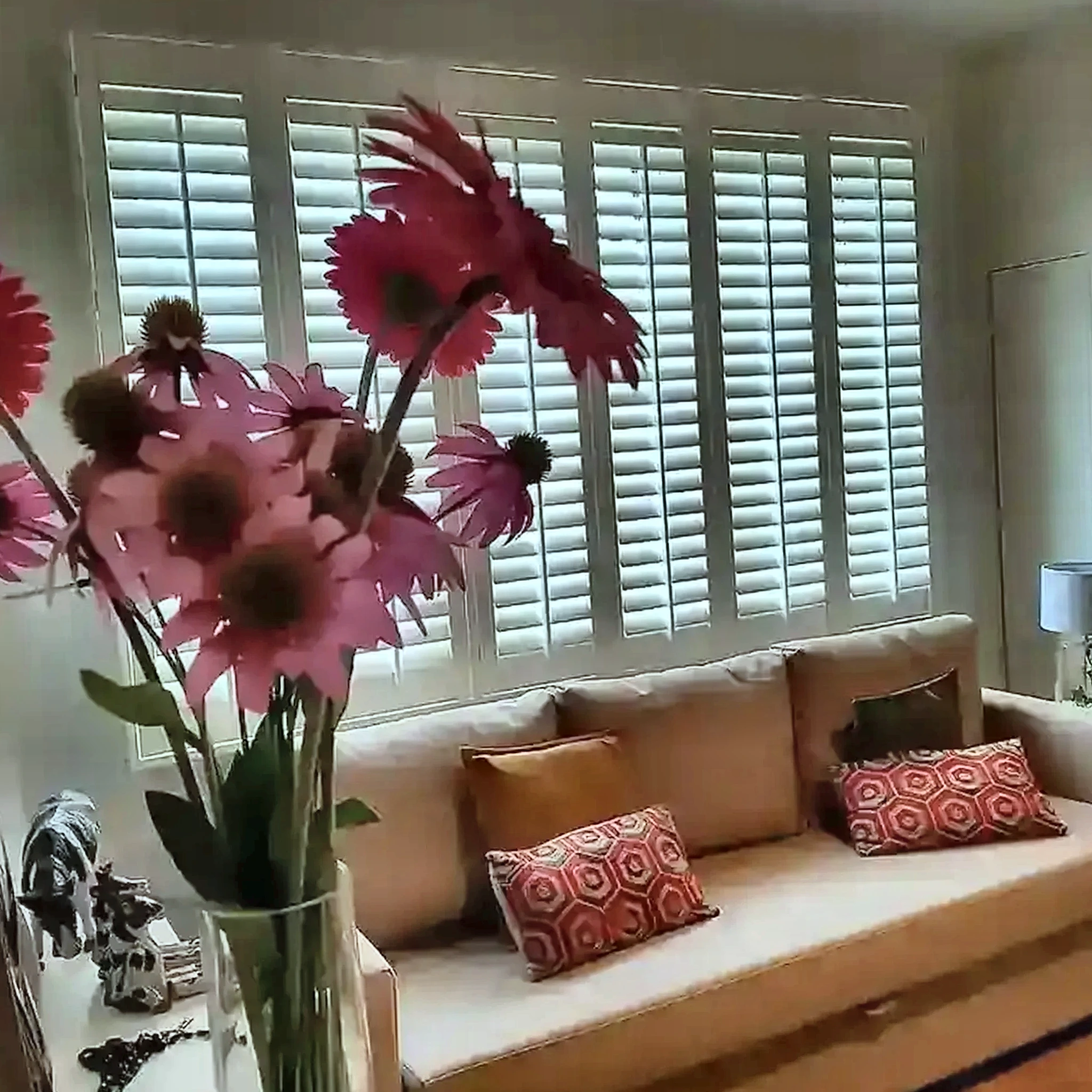 Witte shutters achter een zitbank